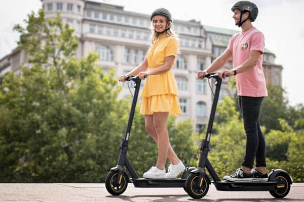 Two people riding on their electric segway ninebot scooters
